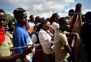 Students evacuated from Moi University listen to an address by Interior Minister for Security Joseph Ole Nkaissery before they are transported to their home regions from a holding area on April 3, 2015.  (Photo: Carl de Souza/Getty Images)
