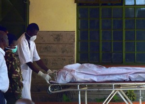 A man pulls a stretcher with the covered body of one of the students massacred by Somalia's Shebab Islamists at a Kenyan university, at the Chiromo funeral parlour in Nairobi on April 3, 2015. The bodies of dozens of students massacred by Somalia's Shebab Islamists at a Kenyan university in Garissa arrived in the capital today, as grieving relatives faced a desperate wait to receive the remains of their loved ones. (Photo: Tony Karumba/GETTY IMAGES)