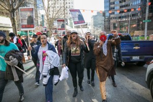 Che Taylor's wife, Brenda Taylor, marches next to Che's brother. Credit: Alex Garland