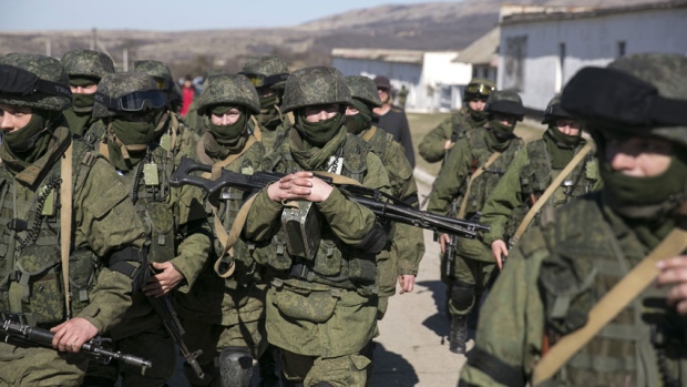 Russian_Troops_in_Crimea Military personnel, believed to be Russian servicemen, walk outside the territory of a Ukrainian military unit in Crimea. A Ukrainian mission to the United Nations claims 16,000 Russian troops have massed in Crimea. (Baz Ratner/Reuters)