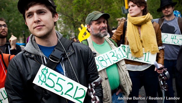 OCCUPY WALL STREET DEMONSTRATORS PARTICIPATING IN A STREET-THEATER PRODUCTION WEAR SIGNS AROUND THEIR NECK REPRESENTING THEIR STUDENT DEBT DURING A PROTEST AGAINST THE RISING NATIONAL STUDENT DEBT IN UNION SQUARE, IN NEW YORK