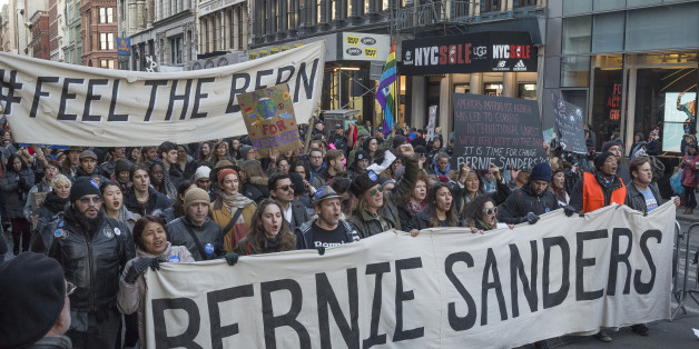 Demonstrators hold signs and chant in support of Bernie