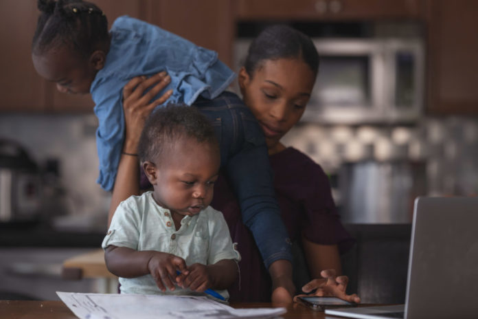 A young mom working from home with small children