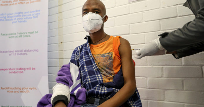 A volunteer receives an injection from a medical worker during the country's first human clinical trial for a potential vaccine against the novel coronavirus, in Soweto